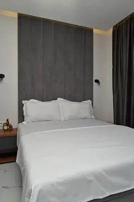 a large bed with white sheets and pillows at Stay at Jimi Ulcinj in Ulcinj