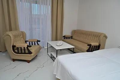 a hotel room with a bed and two chairs and a table at Stay at Jimi Ulcinj in Ulcinj