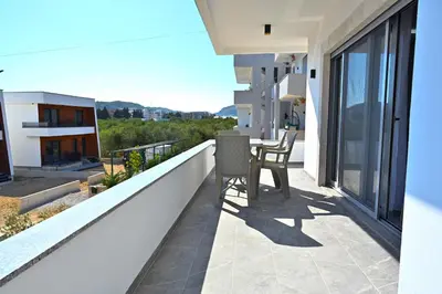 a balcony with a table and chairs on a building at Stay at Jimi Ulcinj in Ulcinj