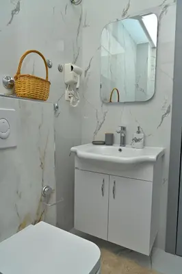 a bathroom with a white sink and a mirror at Stay at Jimi Ulcinj in Ulcinj