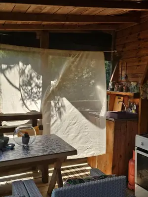 a kitchen with a table and a curtain in a house at Sunrise in Ulcinj