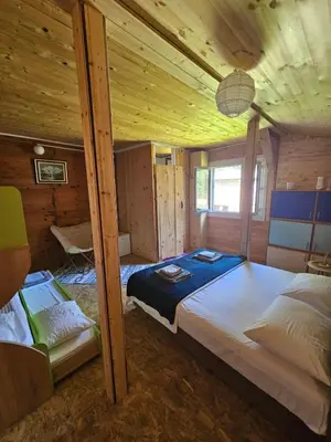a bedroom with two beds in a wooden cabin at Sunrise in Ulcinj