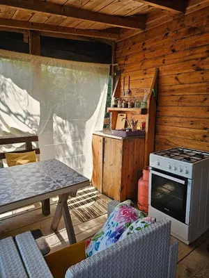 a kitchen with a stove and a table in a cabin at Sunrise in Ulcinj