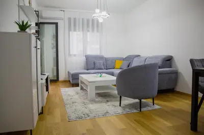 a living room with a couch and a table at Urban Nest - New City in Podgorica