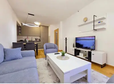 a living room with a couch and a table at Urban Nest - New City in Podgorica