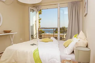 a bedroom with a bed with a large window at Peaceful Sea View Apartment in Bar