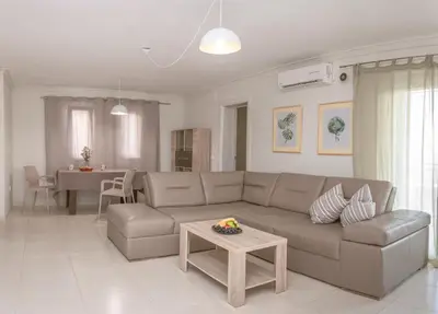 a living room with a couch and a table at Peaceful Sea View Apartment in Bar
