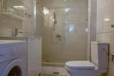 a bathroom with a shower and a toilet and a sink at Peaceful Sea View Apartment in Bar
