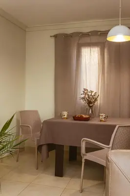 a dining room with a table and chairs and a window at Peaceful Sea View Apartment in Bar