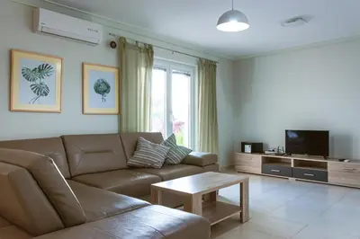 a living room with a brown couch and a table at Peaceful Sea View Apartment in Bar