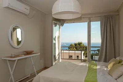 a bedroom with a bed and a large window at Peaceful Sea View Apartment in Bar