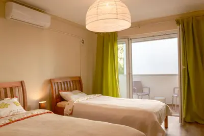 a bedroom with two beds and a large window at Peaceful Sea View Apartment in Bar