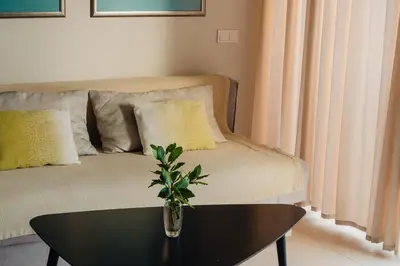 a living room with a couch and a table at Sea View Retreat with Pool in Bar