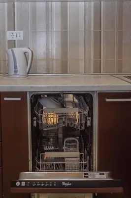 an open dishwasher with a dish rack in it at Sea View Retreat with Pool in Bar