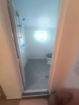 a bathroom with a shower and a toilet at Asko Villa Apartment in Ulcinj