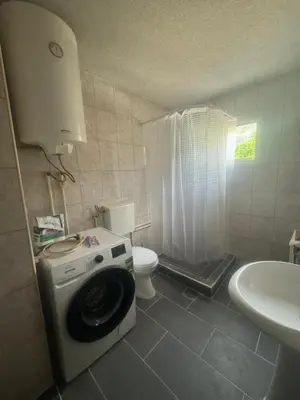a small bathroom with a washing machine in it at Apartmani Đurović - Sutomore in Bar
