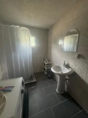 a bathroom with a white sink and a mirror at Apartmani Đurović - Sutomore in Bar