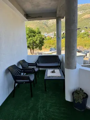a patio with chairs and a table and a view at Apartmani Đurović - Sutomore in Bar