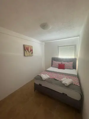 a small bedroom with a bed in a room at Apartmani Đurović - Sutomore in Bar