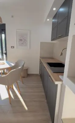 a kitchen with a table and a dining room at Apartments Lj in Ulcinj