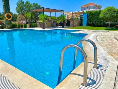 a large swimming pool with blue water at Apartments Lj in Ulcinj