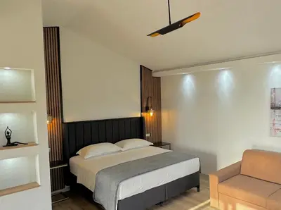 a bedroom with a bed and a chair at Apartments Lj in Ulcinj