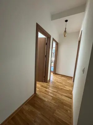 an empty room with a wooden floor and a door at Comfort Stylish Apartment IVSOLE in Budva