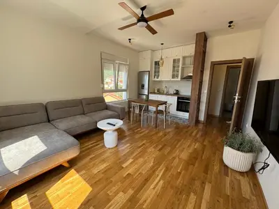 a living room with a couch and a table at Comfort Stylish Apartment IVSOLE in Budva