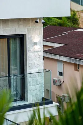 a view of a building with a glass balcony at Lux Apartments Villa B-L-S in Budva