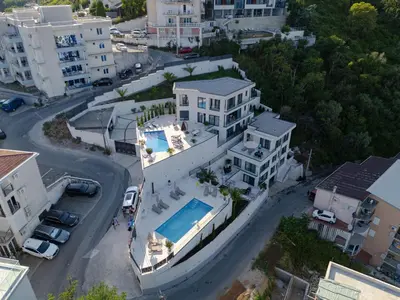 an aerial view of a house with a swimming pool at Lux Apartments Villa B-L-S in Budva
