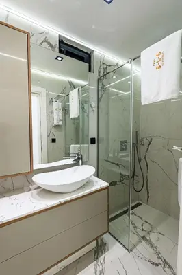 a bathroom with a sink and a glass shower at Lux Apartments Villa B-L-S in Budva