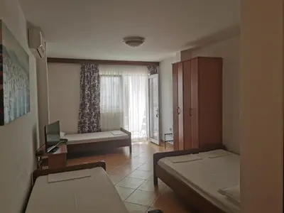 a small room with two beds and a window at Apartment Aleksic Becici in Becici