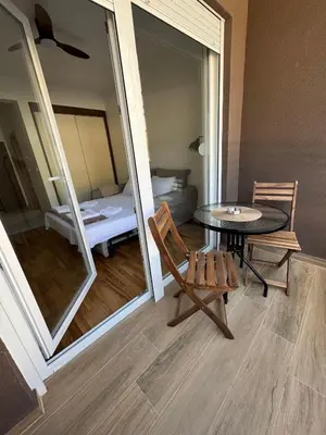 a room with a table and a room with a bed at Stylish Studio IVSOLE in Budva