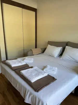a bed with towels on top of it at Stylish Studio IVSOLE in Budva