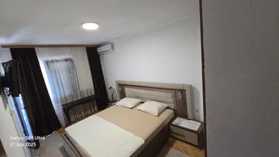 a small bedroom with a bed and a window at BETA Hause in Ulcinj