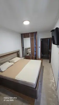 a bedroom with a large bed and a television at BETA Hause in Ulcinj