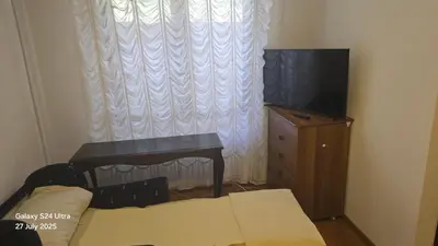 a living room with a tv and a table and a couch at BETA Hause in Ulcinj