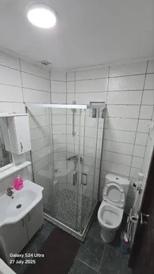 a bathroom with a shower and a toilet and a sink at BETA Hause in Ulcinj