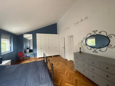 a bedroom with a bed and a dresser with a mirror at Stunning view designer apartment in Budva