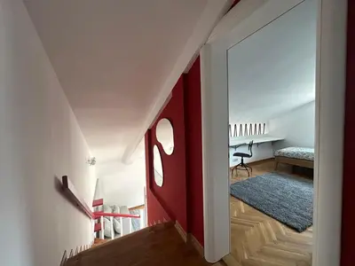 a hallway with a red accent wall in a house at Stunning view designer apartment in Budva