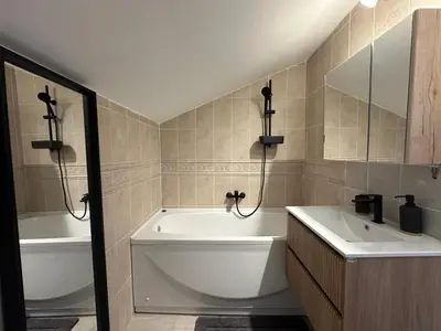 a bathroom with a tub and a sink and a bath tub at Stunning view designer apartment in Budva