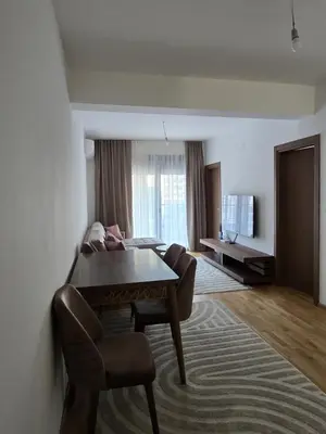 a living room with a table and a couch at Monika Dream Apartment in Budva