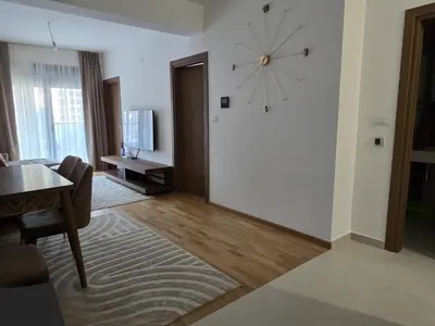 a living room with a clock on the wall at Monika Dream Apartment in Budva