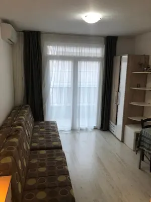 a living room with a couch and a large window at Studio Budva in Budva
