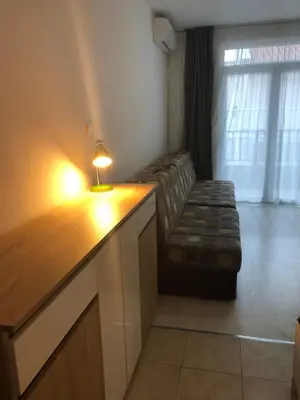 a living room with a couch and a table with a lamp at Studio Budva in Budva