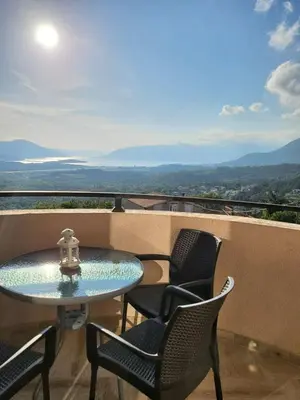 a table and chairs on a balcony with a view at Sunset Vista Kotor in Kotor