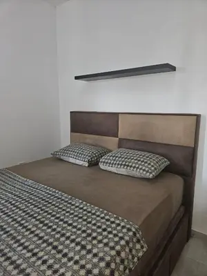 a bed with two pillows on top of it at Sunset Vista Kotor in Kotor