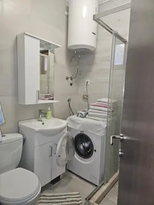 a bathroom with a washing machine and a sink at Sunset Vista Kotor in Kotor