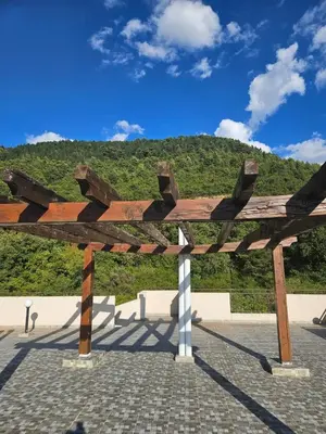 a wooden bench with a mountain in the background at Sunset Vista Kotor in Kotor