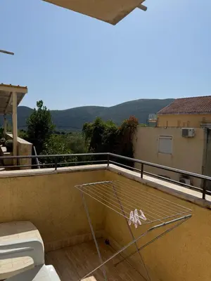 a glass table on the roof of a house at Monte Lastva Apartments in Podlastva